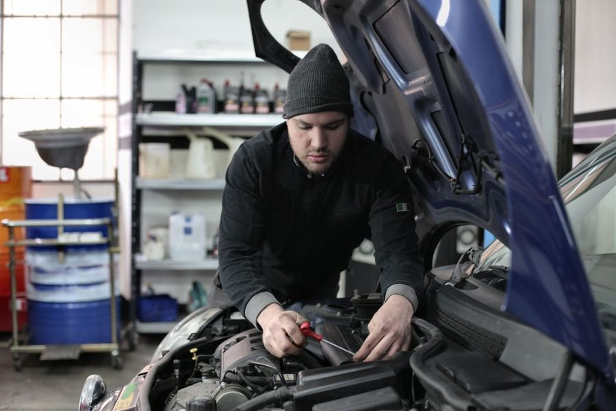 Mechanic working on a car engine