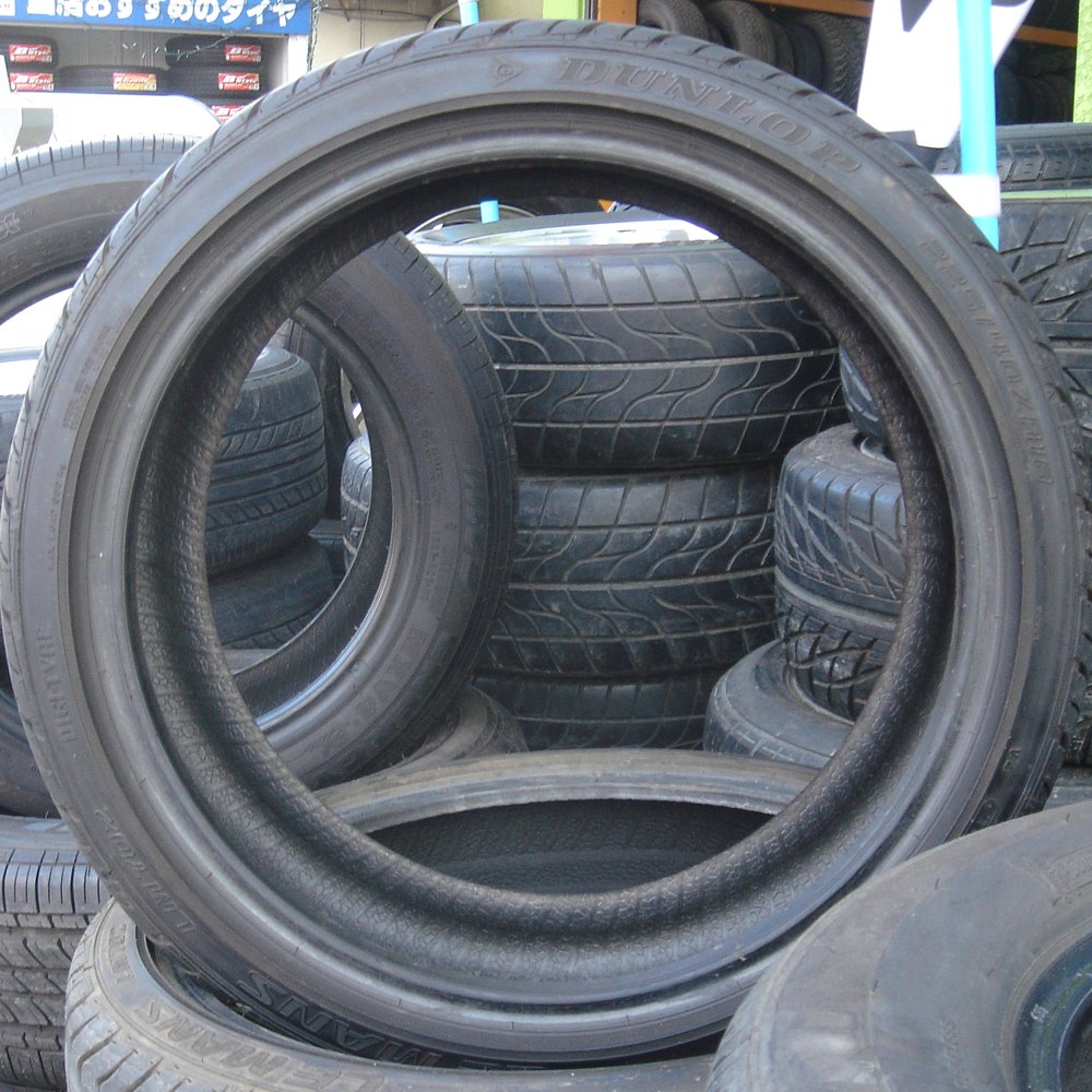 Automotive tires stacked at a tire shop